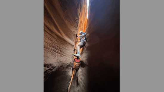 Root Roepke Canyoneering in Canyonlands National Park when the slot is too small to wear your backpack.